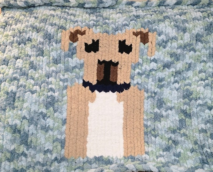Fur Ever Warm chunky knit blanket close up with a textured blue and green background