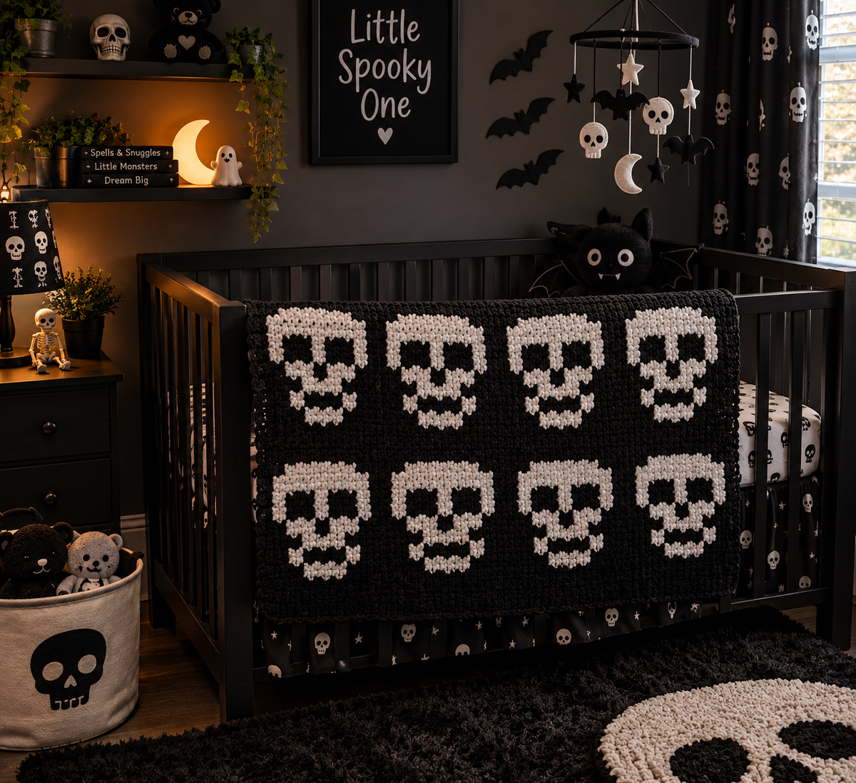 A Halloween-themed nursery setup featuring a black crib with a black and white skull-patterned blanket, matching skull-print curtains, a black nightstand, and a white storage bin with a black skull graphic.