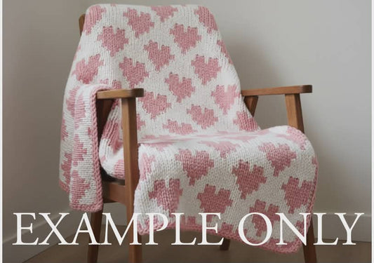 Pink and white patterned blanket draped over a wooden chair with 'EXAMPLE ONLY' text overlay.