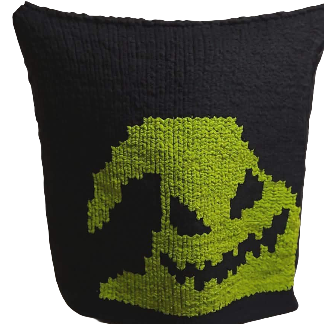 Black pillow with a green ghost face design on a white background