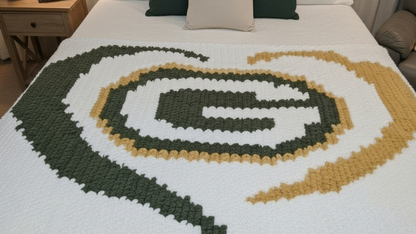Crocheted blanket with a logo on a bed