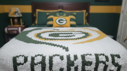 Bedspread with Green Bay Packers logo and text on a bed in a room with sports-themed decor.